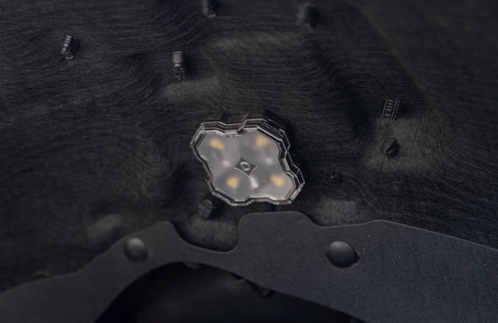 One Diode Dynamics RGBW LED Rock Light mounted in wheel well of van
