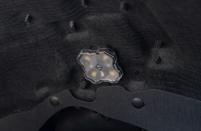 One Diode Dynamics RGBW LED Rock Light mounted in wheel well of van