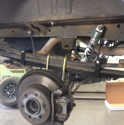 Installed Van Compass Mini Leaf Spring pack underneath factory 2 pack leaf springs